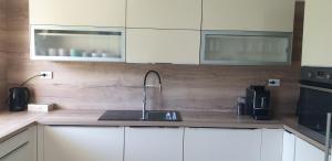 a kitchen with white cabinets and a sink at Apartments Mare in Banjol