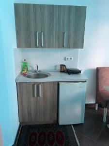 a small kitchen with a sink and a refrigerator at Apartmani Blu Notte in Ulcinj