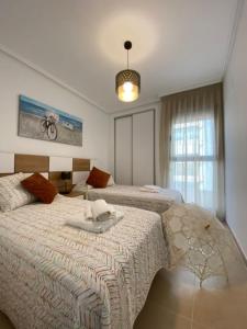 a large bedroom with two beds and a window at PLAZAMAYOR in Calpe