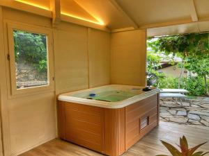 a jacuzzi tub in a room with a window at La casa di Elda in Sanremo