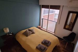 a bedroom with a bed with two pillows on it at Ubicación privilegiada!!! Plaza España in Mendoza