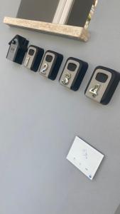 a group of cell phones are on a wall at Grey House Bed & Breakfast in Latina
