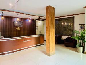 a lobby of a restaurant with a table and a bar at Fiesta Inn Hotel & Resorts Multan in Multan