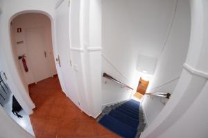 a hallway with blue stairs and a white door at Casa do Convento AL/141600 in Coimbra