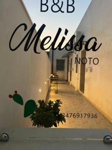 a sign that reads bc metella modica on a building at B&B Melissa in Noto