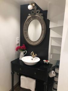 a bathroom with a sink and a mirror at Private space with 2 bedrooms in Huddinge