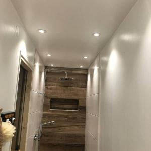 a bathroom with a shower with a wooden wall at Private space with 2 bedrooms in Huddinge +55 photos