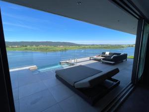 a bedroom with a large window with a view of the water at Le Nordic in Grande Riviere