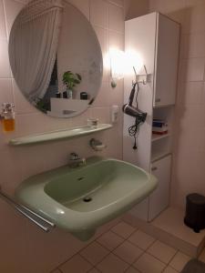 a bathroom with a green sink and a mirror at Willy und Gudrun in Rheda-Wiedenbrück +31 photos