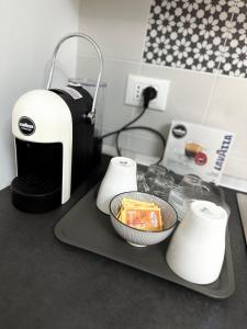 a kitchen counter with a coffee maker and paper towels at Casa InCentro in Pescara