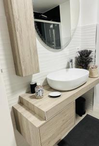 a bathroom with a white sink and a mirror at Casa InCentro in Pescara +12 photos