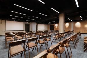 an empty lecture hall with desks and chairs at Barceló Warsaw Powiśle in Warsaw