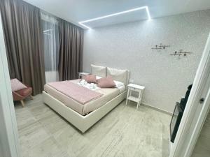 a bedroom with a white bed with pink pillows at Bobbio Holiday Rome in Rome