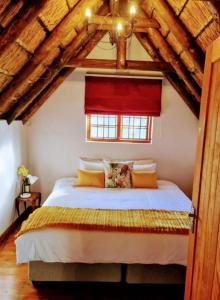 a bedroom with a large bed with a red window at Mead, Pinelands in Cape Town +37 photos