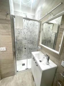 a bathroom with a shower and a sink and a mirror at Bobbio Holiday Rome in Rome