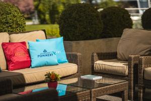 2 rieten stoelen en een salontafel op een patio bij Beau Rivage Hotel in Neuchâtel