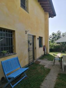 a blue chair sitting in front of a house at Alle porte di Marano in Marano