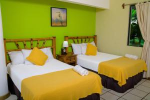 Una cama o camas en una habitación de Banana Palms Hotel