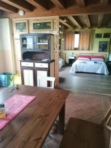 a living room with a table and a bed at Alle porte di Marano in Marano +5 photos