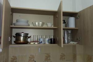 a kitchen shelf with dishes and pots and pans at Beautiful apartment/Hermoso apartamento! in Lima