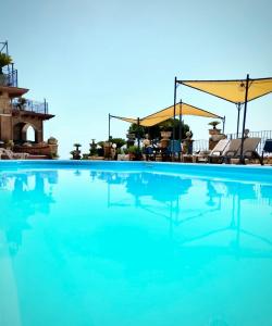 a large swimming pool with blue water at Isola Verde in Durazzano