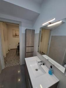a bathroom with a white sink and a mirror at Altamira White & Bright in Almería