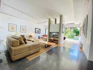 a large living room with a couch and a fireplace at Narcisses House in La Marsa