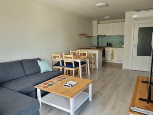 a living room with a couch and a table and a kitchen at ATEA apartments in Kavarna