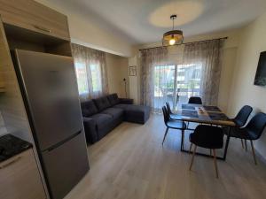 a living room with a couch and a table at Leks Terra Apartments #3 with private parking in Nikiti
