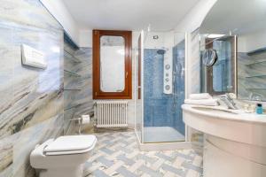 a bathroom with a toilet and a sink and a shower at Ca' Mandorla 027042loc09523 in Venice +44 photos