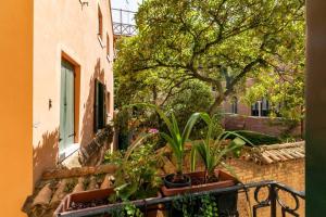 a balcony with potted plants on the side of a building at Ca' Mandorla 027042loc09523 in Venice