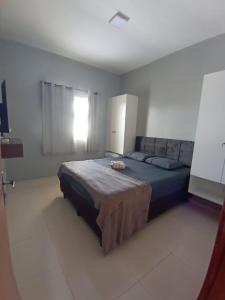 a bedroom with a large bed in a room at Dunas Residence Casa n16 in Santo Amaro