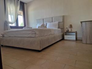 a bedroom with a large bed and a window at On the wave studios Spitakia sto kyma in Nikiti