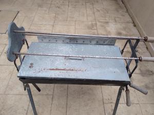 an old metal bench sitting on a tile floor at Danitsea vila in Larnaca