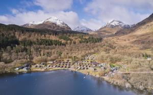 an aerial view of a lake with mountains in the background at Loch Lomond Holiday Park in Inversnaid