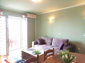 a living room with a couch and a table at Meeresblick Apartment S4 in Promajna