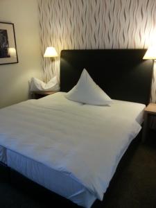 Postel nebo postele na pokoji v ubytování Hotel Quellenhof