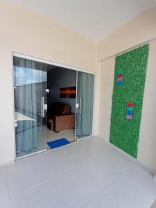 a room with a glass wall with a couch in it at Dunas Residence Casa n16 in Santo Amaro