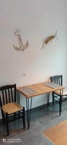 a table and two chairs and a table and a table and chairs at Buenavista apartment in Ipsos +8 photos