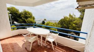 a balcony with a table and chairs and a view at TRES CARABELAS 249 in Alcossebre