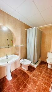 a bathroom with a sink and a toilet and a shower at TRES CARABELAS 249 in Alcossebre
