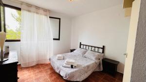 a bedroom with a bed with two towels on it at TRES CARABELAS 249 in Alcossebre
