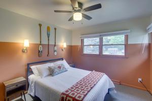 a bedroom with a bed and a ceiling fan at Updated Plymouth Home about 5 Mi to Road America! in Plymouth