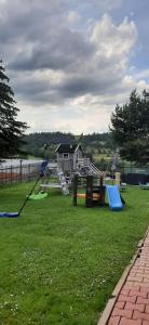 a park with a playground with a slide and swings at U Leny in Bukowina Tatrzańska