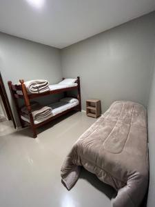 a bedroom with a bed and bunk beds in it at Apart JJ - Departamento céntrico - amueblado a estrenar in Paso de los Libres