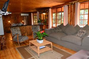 a living room with a couch and a table at On Golden Pond - Mount Amanzi in Hartbeespoort