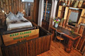 a bedroom with a bed and a desk in a room at On Golden Pond - Mount Amanzi in Hartbeespoort