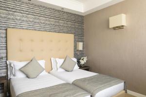 Łóżko lub łóżka w pokoju w obiekcie Windsor Hotel Milano