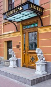 two statues of lions in front of a hotel at Ligotel in Saint Petersburg