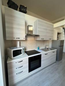a kitchen with a microwave oven and a sink at LA CASETTA in Cagliari +10 photos